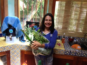 Regina Quintero with a fresh harvest of organic kale.